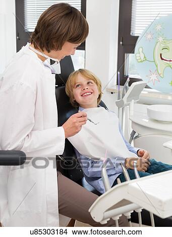 Picture - Boy in dentists chair at check up. Fotosearch
