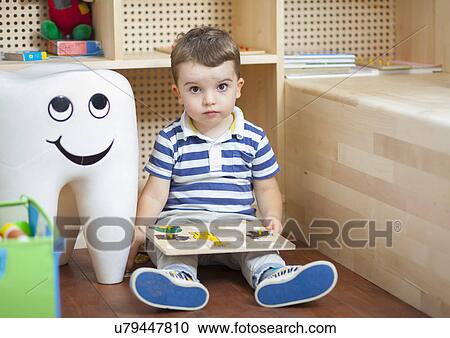 Boy with puzzle at dentists View Large Photo Image Stock Image - Boy with puzzle at dentists. Fotosearch