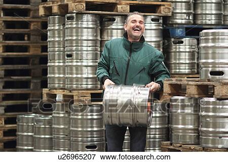 Brewery worker carrying barrel View Large Photo Image Stock Photo - Brewery worker carrying barrel. Fotosearch