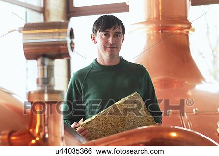 Brewery worker operating machine View Large Photo Image Stock Photograph - Brewery worker operating machine. Fotosearch
