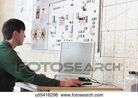 Brewery worker operating machine View Large Photo Image Stock Photograph - Brewery worker operating machine. Fotosearch