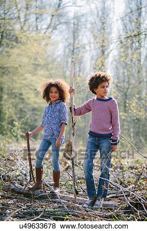 Brother and sister playing together in woods View Large Photo Image Stock Photo - Brother and sister playing together in woods. Fotosearch