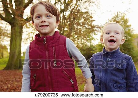 Brothers in park, holding hands View Large Photo Image Stock Photography - Brothers in park, holding hands. Fotosearch