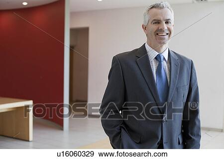 Businessman in waiting area of office View Large Photo Image Stock Photo - Businessman in waiting area of office. Fotosearch