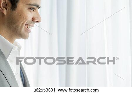 Businessman looking out of window View Large Photo Image Stock Image - Businessman looking out of window. Fotosearch