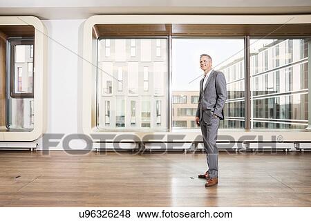 Stock Photo - Businessman standing in office. Fotosearch