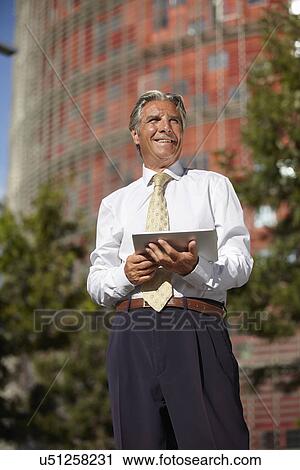 Stock Image - Businessman using digital tablet. Fotosearch
