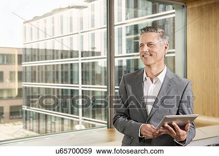 Stock Photo - Businessman using digital tablet. Fotosearch