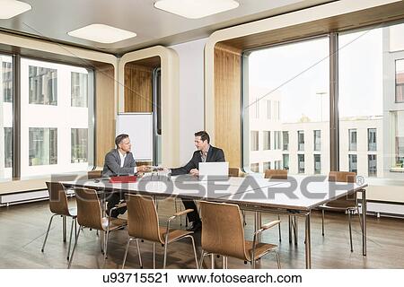 Businessmen meeting in conference room View Large Photo Image Stock Image - Businessmen meeting in conference room. Fotosearch