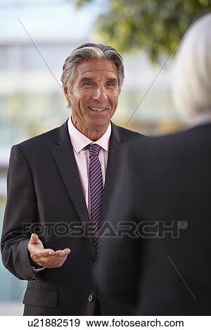Businesspeople having conversation View Large Photo Image Stock Photo - Businesspeople having conversation. Fotosearch