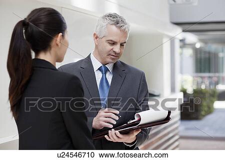 Businesspeople standing having conversation View Large Photo Image Stock Image - Businesspeople standing having conversation. Fotosearch