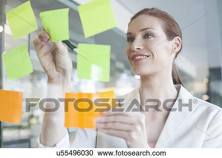 Businesswoman brainstorming using sticky notes View Large Photo Image Stock Image - Businesswoman brainstorming using sticky notes. Fotosearch
