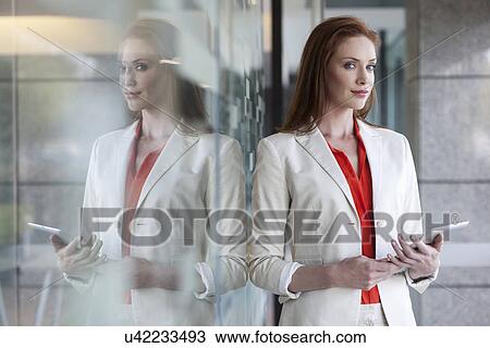 Businesswoman holding digital tablet View Large Photo Image Stock Image - Businesswoman holding digital tablet. Fotosearch