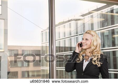 Stock Photograph - Businesswoman making telephone call. Fotosearch
