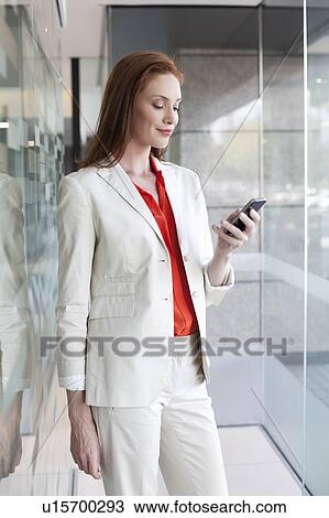 Stock Image - Businesswoman using smartphone. Fotosearch