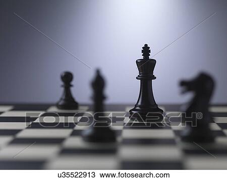 Chess pieces on a board showing king View Large Photo Image Stock Image - Chess pieces on a board showing king. Fotosearch