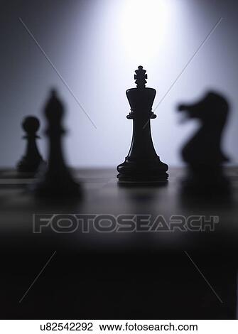 Chess pieces on a board showing king View Large Photo Image Stock Image - Chess pieces on a board showing king. Fotosearch