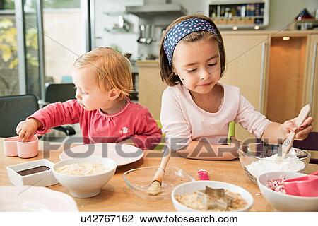 Stock Image - Children baking in kitchen. Fotosearch