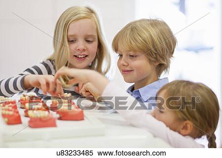 Children looking at false teeth View Large Photo Image Stock Photography - Children looking at false teeth. Fotosearch