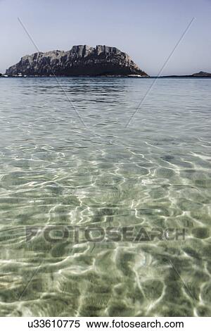 Clear water with rocks in background, Porto Istana, Sardinia, Italy View Large Photo Image Stock Photography - Clear water with rocks in background, Porto Istana, Sardinia, Italy. Fotosearch