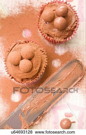 Stock Photo - Close up of chocolate cupcakes and palette knife. Fotosearch