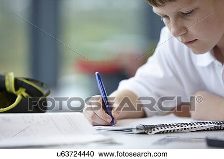 Close up of schoolboy writing in class View Large Photo Image Stock Image - Close up of schoolboy writing in class. Fotosearch