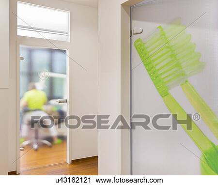 Close up of toothbrush, dentist in background View Large Photo Image Stock Image - Close up of toothbrush, dentist in background. Fotosearch