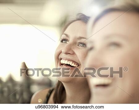 Close up shot of two young female friends laughing View Large Photo Image Picture - Close up shot of two young female friends laughing. Fotosearch