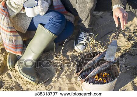 Cooking fish on the beach View Large Photo Image Stock Photo - Cooking fish on the beach. Fotosearch