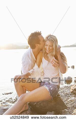 Stock Photo - Couple at lakeside, Cumbria, England, UK. Fotosearch