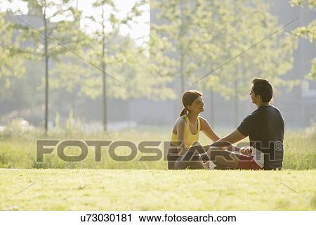 Couple sitting in park View Large Photo Image Stock Image - Couple sitting in park. Fotosearch