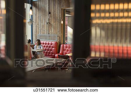 Couple sitting in restaurant booth View Large Photo Image Stock Image - Couple sitting in restaurant booth. Fotosearch