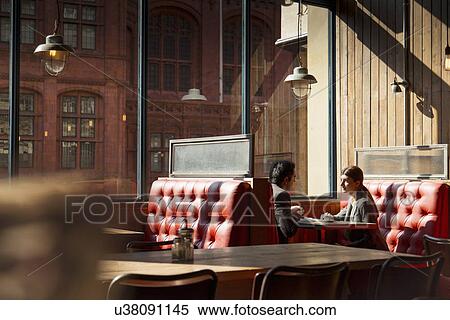 Couple sitting in restaurant booth View Large Photo Image Stock Photography - Couple sitting in restaurant booth. Fotosearch