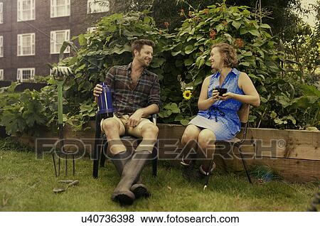 Stock Photo - Couple taking a break on council estate allotment. Fotosearch