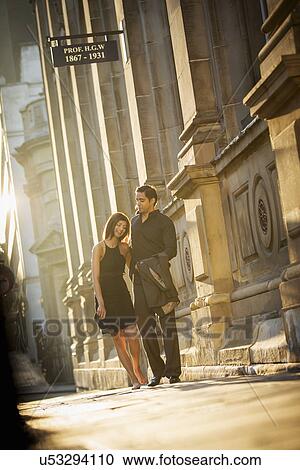 Couple walking on pavement, Birmingham, England, UK View Large Photo Image Stock Image - Couple walking on pavement, Birmingham, England, UK. Fotosearch