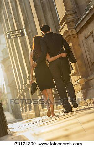 Couple walking on pavement, Birmingham, England, UK View Large Photo Image Stock Photo - Couple walking on pavement, Birmingham, England, UK. Fotosearch