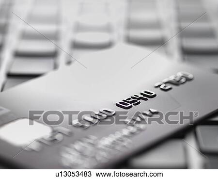 Stock Image - Credit card on laptop to illustrate internet shopping and internet fraud. Fotosearch