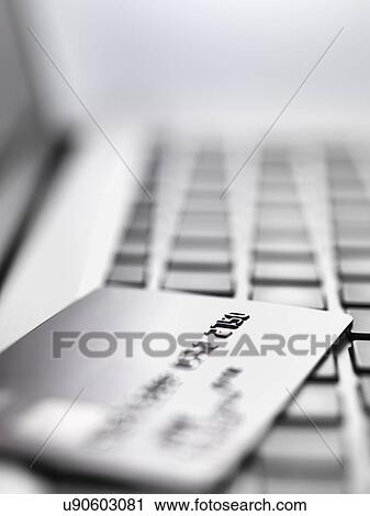 Credit card on laptop to illustrate internet shopping and internet fraud View Large Photo Image Stock Image - Credit card on laptop to illustrate internet shopping and internet fraud. Fotosearch