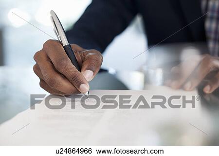 Cropped image of businessman signing paperwork View Large Photo Image Stock Photograph - Cropped image of businessman signing paperwork. Fotosearch