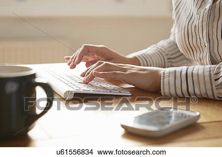 Cropped image of woman typing on wireless keyboard View Large Photo Image Picture - Cropped image of woman typing on wireless keyboard. Fotosearch