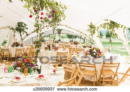 Decorated tables in garden marquee at wedding reception View Large Photo Image Stock Photo - Decorated tables in garden marquee at wedding reception. Fotosearch