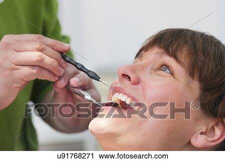Dentist working on female patient, close up View Large Photo Image Stock Image - Dentist working on female patient, close up. Fotosearch