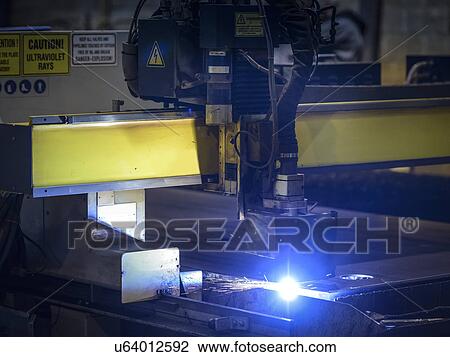 Stock Image - Detail of plasma cutter in factory. Fotosearch