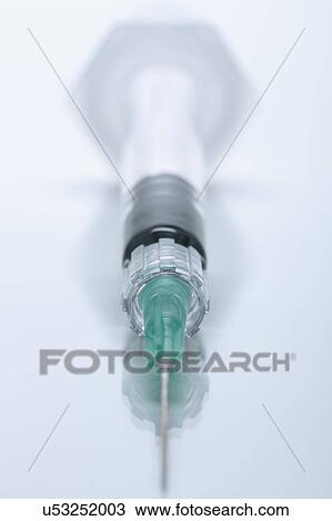Stock Image - Disposable plastic medical syringe with attached hypodermic needle. Fotosearch