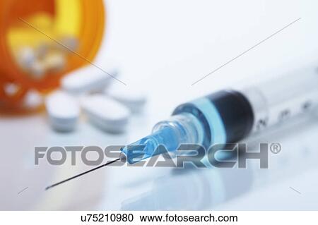 Disposable plastic medical syringe with attached hypodermic needle. Pill bottle and pills in the background View Large Photo Image Stock Image - Disposable plastic medical syringe with attached hypodermic needle. Pill bottle and pills in the background. Fotosearch