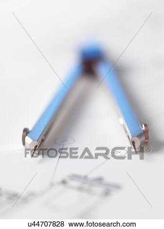 Stock Photo - Dividers sitting on engineering drawing used in the measurement of design features. Fotosearch