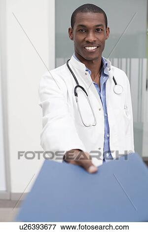 Stock Photo - Doctor handing over paperwork. Fotosearch