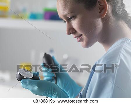 Stock Photography - Doctor taking a blood pressure reading using a sphygmomanometer. Fotosearch