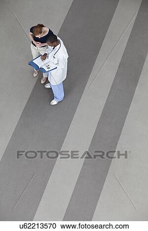 Stock Image - Doctors having conversation. Fotosearch