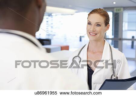 Doctors having conversation View Large Photo Image Stock Photography - Doctors having conversation. Fotosearch